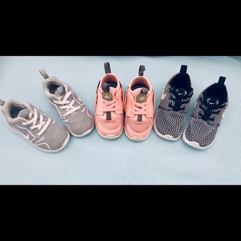 3 pairs of girl’s toddler sized 7 Nike sneakers.